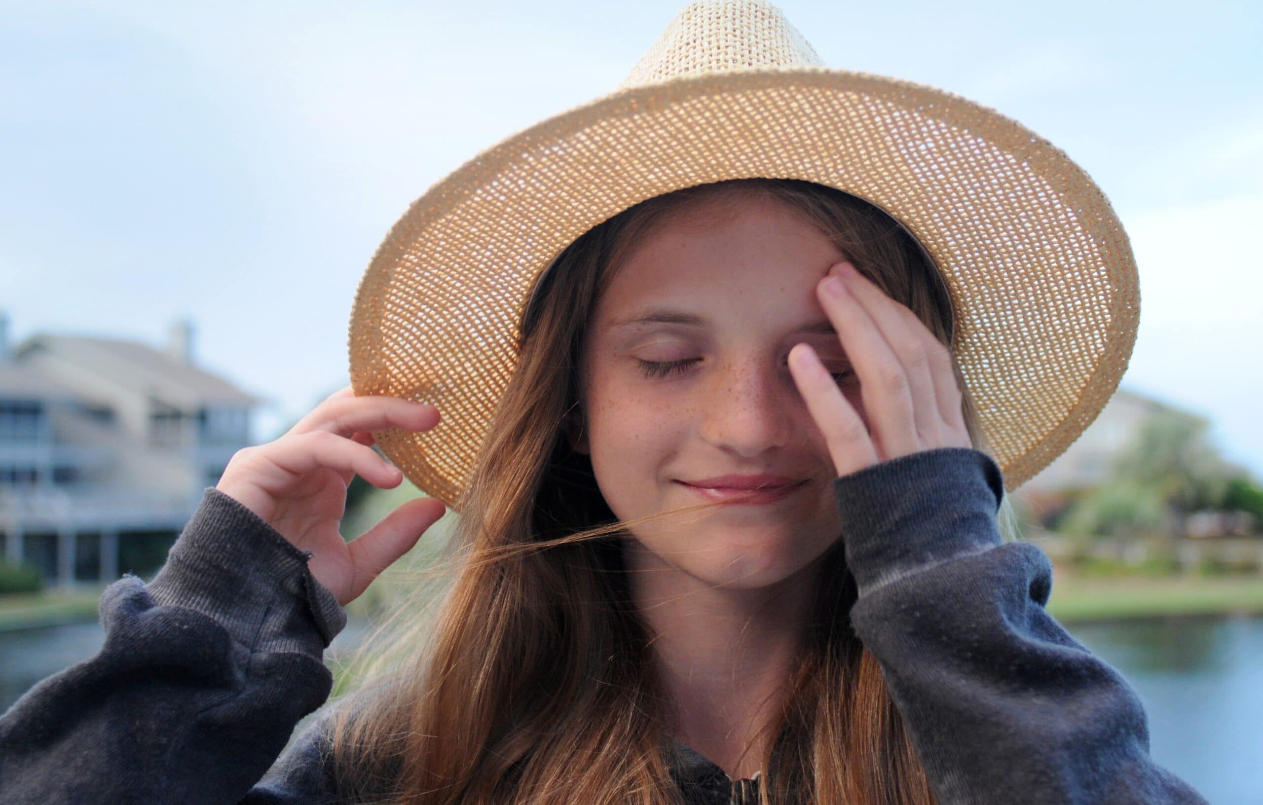 closed eyed woman wearing beige hat during day