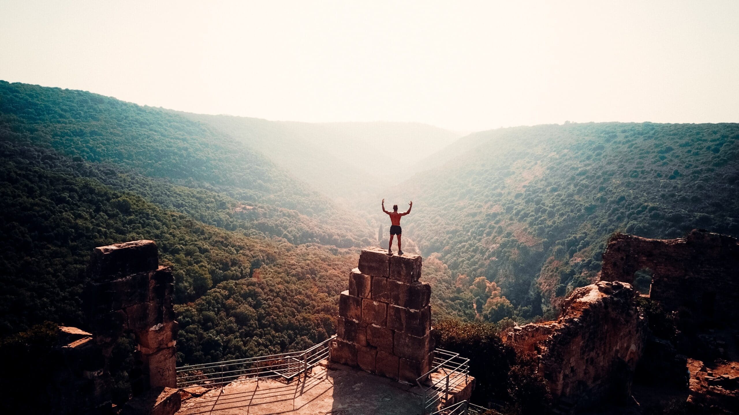 person standing on brown concrete building during daytime